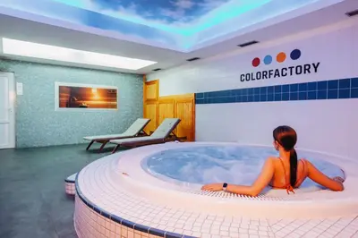 a woman sitting in a hot tub in a waiting room at COLORFACTORY SPA Hotel - Czech Leading Hotels in Prague