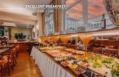 a buffet line of food at a restaurant at COLORFACTORY SPA Hotel - Czech Leading Hotels in Prague
