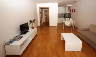a living room with a white couch and a television at Aparthotel Angel in Prague