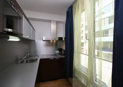 a kitchen with a sink and a window next to a counter at Aparthotel Angel in Prague
