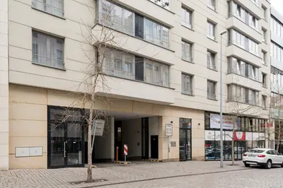 a building on a street with a tree in front of it at Aparthotel Angel in Prague