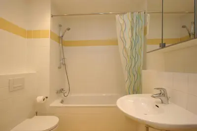 a bathroom with a sink and a tub and a toilet at Aparthotel Angel in Prague