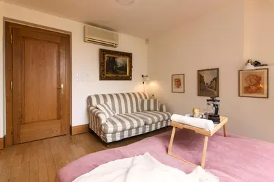 a living room with a couch and a chair at Billionaires Club LOFT Sauna City Center in Prague