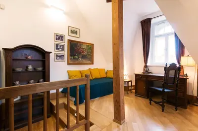 a bedroom with a bed with yellow pillows and a desk at Billionaires Club LOFT Sauna City Center in Prague