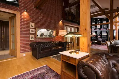a living room with leather furniture and a brick wall at Billionaires Club LOFT Sauna City Center in Prague