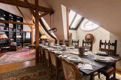 a long dining room with a long table and chairs at Billionaires Club LOFT Sauna City Center in Prague
