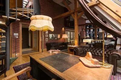 a living room with a couch and a table at Billionaires Club LOFT Sauna City Center in Prague