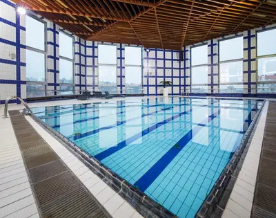 a large swimming pool in a building with windows at OREA Hotel Pyramida Praha in Prague