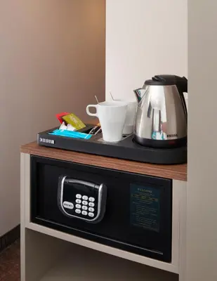 a microwave oven with a coffee maker on top of it at OREA Hotel Pyramida Praha in Prague