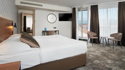 a hotel room with a bed and a desk and chairs at OREA Hotel Pyramida Praha in Prague