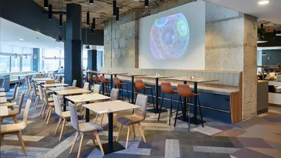 a row of tables and chairs in a restaurant at OREA Hotel Pyramida Praha in Prague