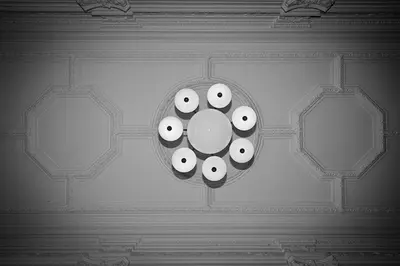 a room with a clock with eyes on the ceiling at Amigo City Centre in Prague
