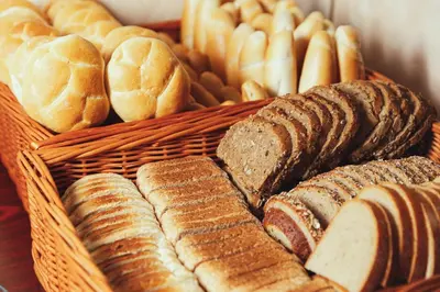 a basket filled with different types of bread at Amigo City Centre in Prague