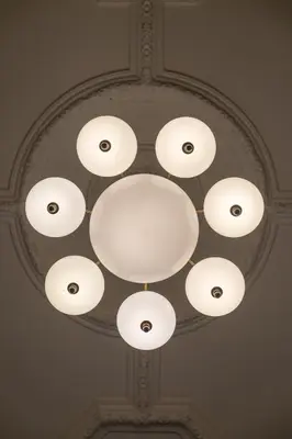 a chandelier with white lights on a ceiling at Amigo City Centre in Prague