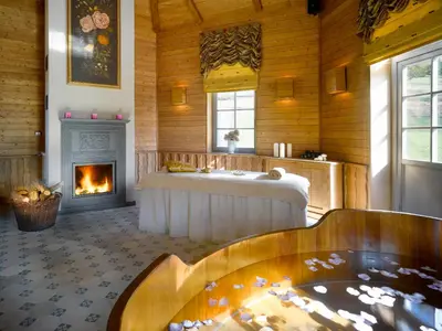 a bath room with a tub and a fireplace at Chateau Mcely in Mcely