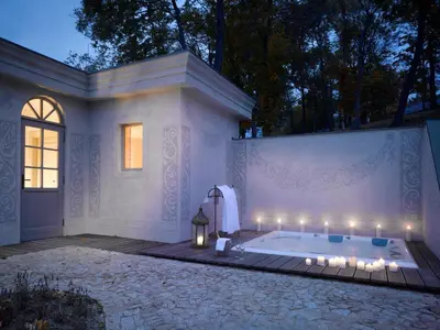 a jacuzzi tub in a backyard at night at Chateau Mcely in Mcely