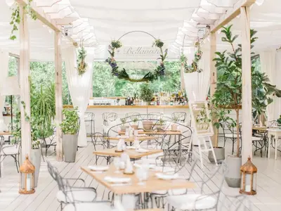 a room with tables and chairs and plants at Chateau Mcely in Mcely