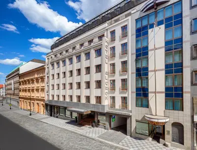 a large white building on a city street at Almanac X Alcron Prague in Prague