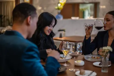 a group of people sitting around a table with wine glasses at Almanac X Alcron Prague in Prague