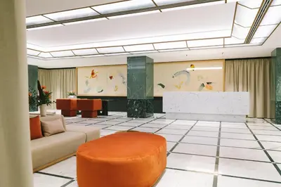a lobby with a couch and a table at Almanac X Alcron Prague in Prague