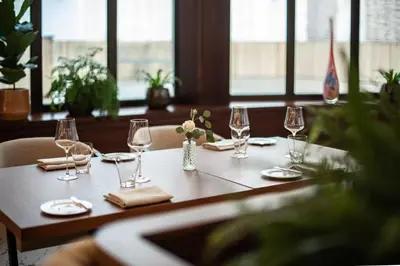a table with wine glasses and napkins on it at Almanac X Alcron Prague in Prague