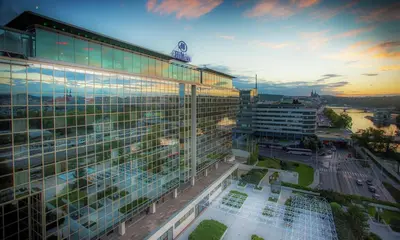 a large building with a lot of windows at dusk at Hilton Prague Atrium in Prague