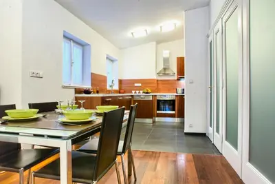 a dining room and kitchen with a table and chairs at Residence Karolina in Prague