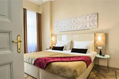 a hotel room with a large bed and a window at Residence Karolina in Prague