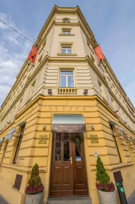 a yellow building with a large wooden door at Prague Centre Plaza in Prague