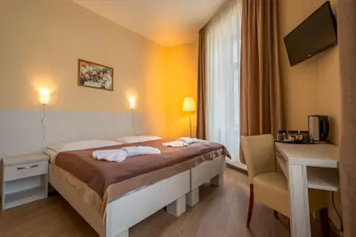 a hotel room with a bed and a desk at Prague Centre Plaza in Prague