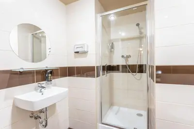 a bathroom with a sink and a shower at Hotel Superior Prague in Prague