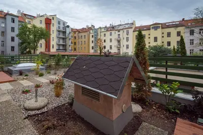 a small house with a black roof in a city at Hotel Superior Prague in Prague