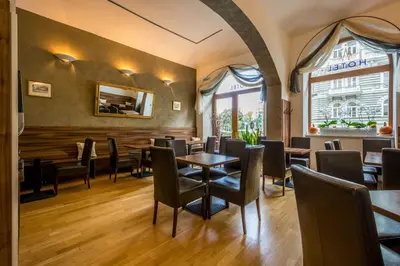 a dining room with tables and chairs in a restaurant at Hotel Superior Prague in Prague