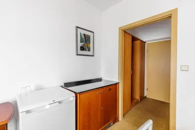 a kitchen with a white stove top oven next to a door at Hotel CHOTOL in Horoměřice