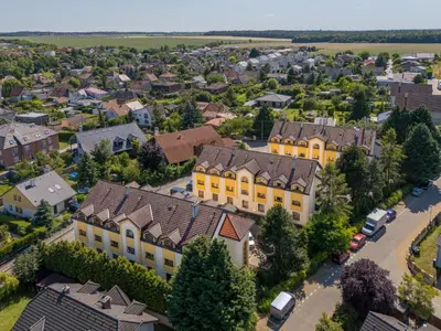 an overhead view of a town with yellow houses at Hotel CHOTOL in Horoměřice