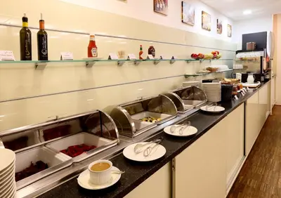 a buffet line in a restaurant with plates of food at Amarilis in Prague