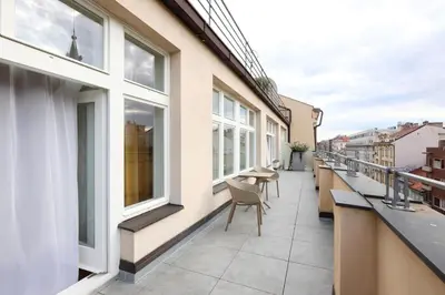 a balcony with chairs and windows on a building at Amarilis in Prague