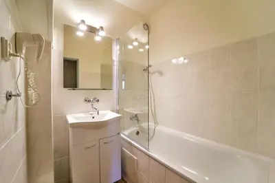 a bathroom with a sink and a tub and a shower at Charles Central in Prague