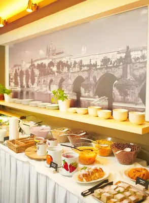 a buffet line with food on a table at Charles Central in Prague
