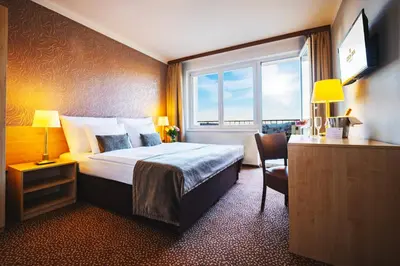 a hotel room with a bed and a window at Charles Central in Prague