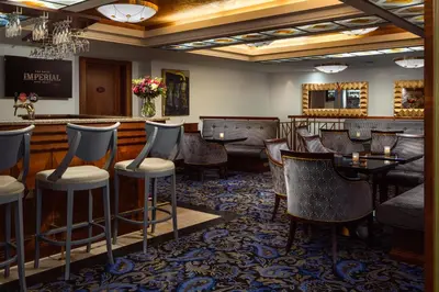 a bar with tables and chairs in a restaurant at Art Deco Imperial Hotel in Prague