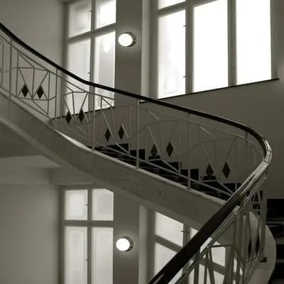 a spiral staircase in a building with windows at Art Deco Imperial Hotel in Prague