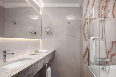 a white bathroom with a sink and a shower at Art Deco Imperial Hotel in Prague