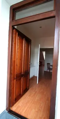 a large wooden door in a room with a wooden floor at Apart Hotel Susa in Prague