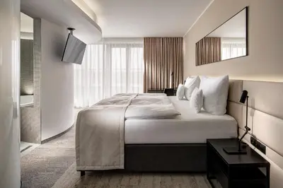 a hotel room with a large bed and a mirror at Clarion Congress Hotel Prague in Prague