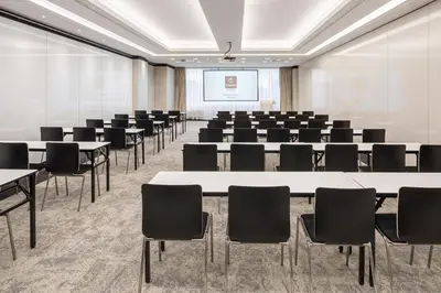a conference room with tables and chairs and a projection screen at Clarion Congress Hotel Prague in Prague