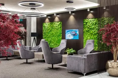 a waiting room with chairs and a green wall at Clarion Congress Hotel Prague in Prague