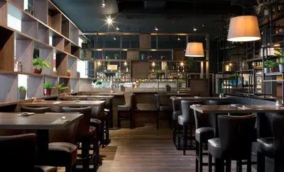 a restaurant with tables and chairs and a bar at Clarion Congress Hotel Prague in Prague