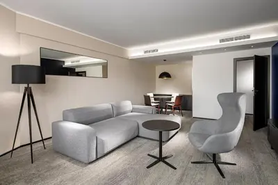 a living room with a couch and chairs and a table at Clarion Congress Hotel Prague in Prague