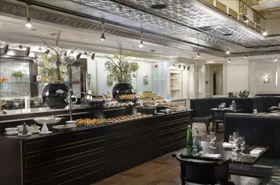 a lobby with a bar and a dining area at Hilton Prague Old Town in Prague